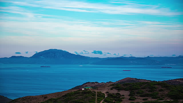 Container ships crossing the Strait of Gibraltar as seen from the Spain looking across at Morocco - time lapse