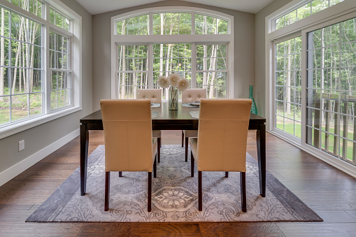 Eating area of home surrounded by glass windows and tons of natural light