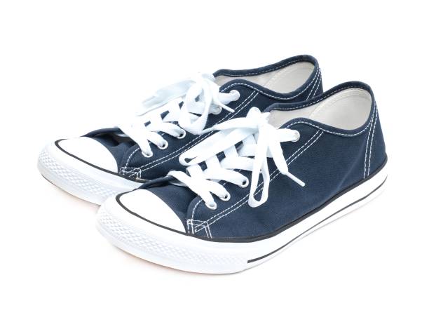 istock A pair of navy blue sneakers isolated on a white background. 1725330949