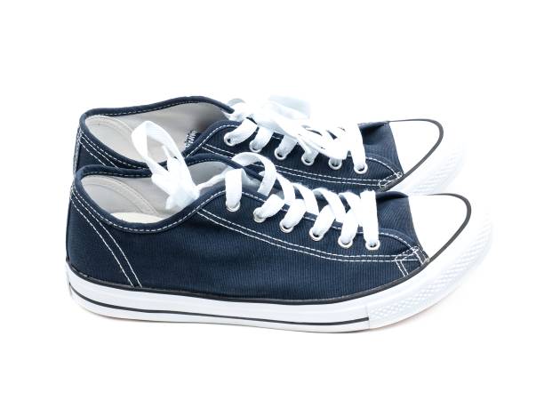 istock A pair of navy blue sneakers isolated on a white background. 1725330958