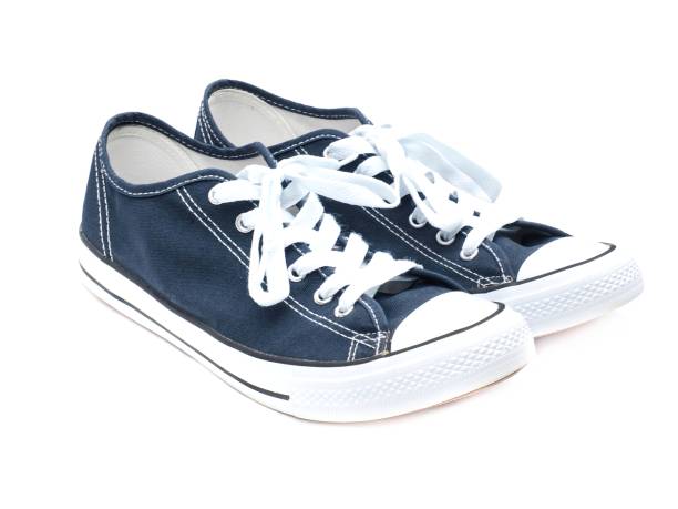 istock A pair of navy blue sneakers isolated on a white background. 1725330979