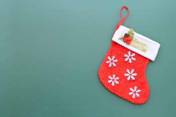 istock red wool winter sock on green background, christmas decoration 1725347674