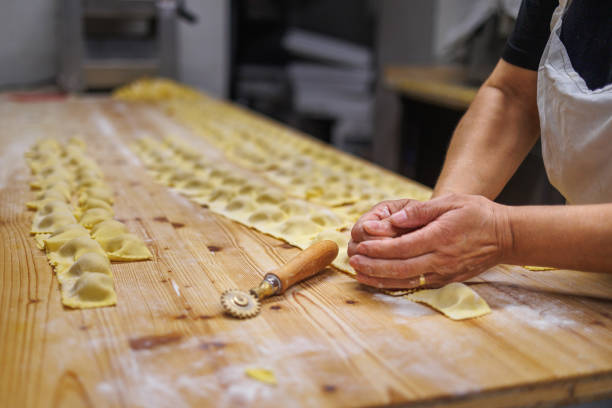 istock Preparing Italian Stuffed Tortelli on a Long Wooden Table 1725348703