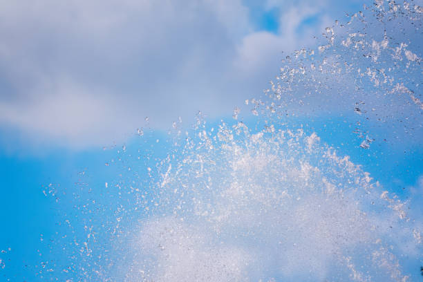 istock Splashes of water against the blue sky background 1725356236
