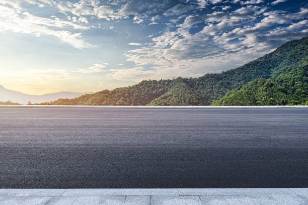 istock Asphalt road and mountains background 1725382100