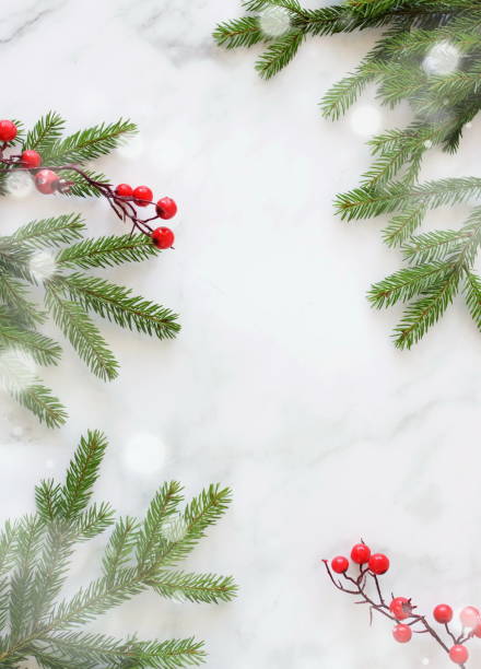 istock Christmas background with copy space. Top view fir tree branches frame on marble backdrop. 1725408046