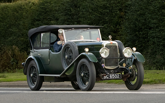 Bicester,Oxon.,UK - Oct 8th 2023: 1930 green Alvis Silver Eagle vintage car driving on an English country road.