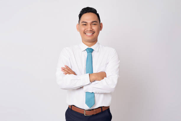 istock Smiling happy young Asian man in formal wear standing confident with folded arms while looking at the camera isolated on white background 1725496231