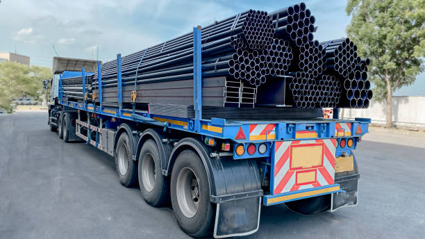 istock Trucks with long trailers carrying steel bars for building construction. Construction steel is ready to be delivered to the customer. 1725496268