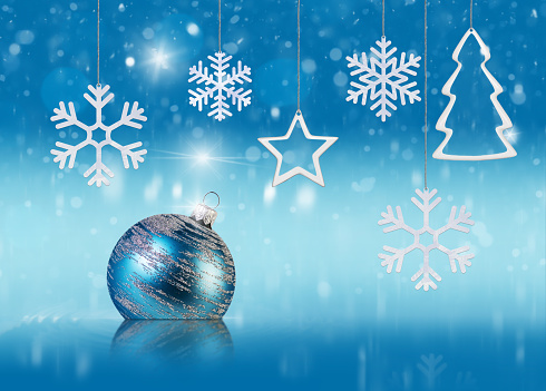 abstract Christmas and New Year concept with christmas decorations, snow, snowflakes and stars on blue tender background