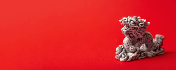 istock Grey dragon statue on a red background. The symbol of 2024. 1725510537