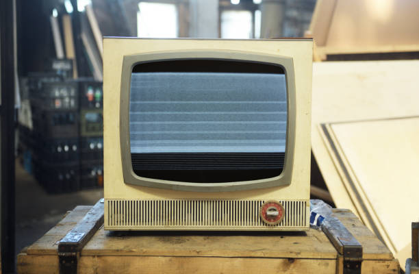 istock An old TV with noise on the screen sits on a box. 1725518359