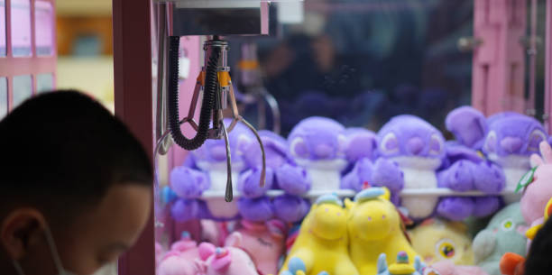 istock kid play claw game in asia arcade for hapiness and fun 1725522831