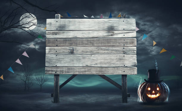 istock Old wooden sign and scary pumpkin 1725534081