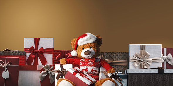Cute Teddy Bear and many Christmas gifts, banner with copy space