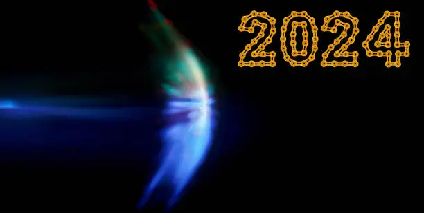 defocused sound barrier light effect on dark background, with 2024 Happy New Year made from golden chain links