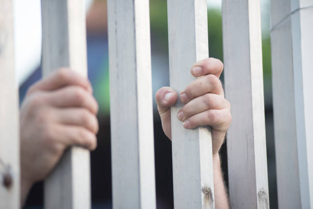 istock prisoner at the window of a prison cell 1725593333