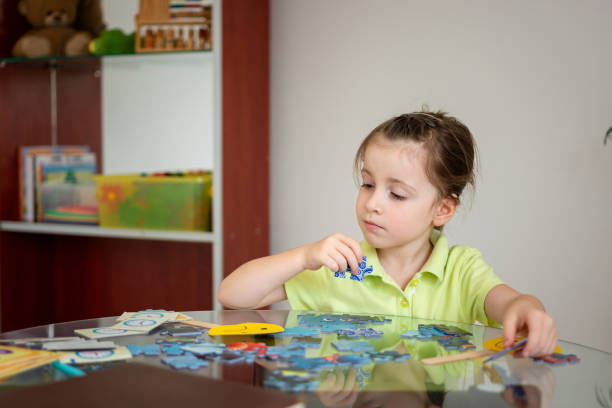 istock Girl solving puzzles at home 1725596750