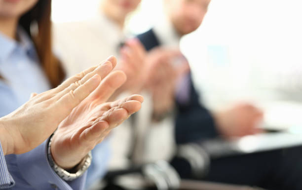 istock Audience hands applauding speaker and host for speaking 1725597334