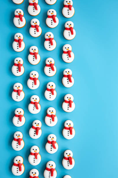 istock Gingerbread snowmen covered with icing on a blue background, flat lay. 1725601785