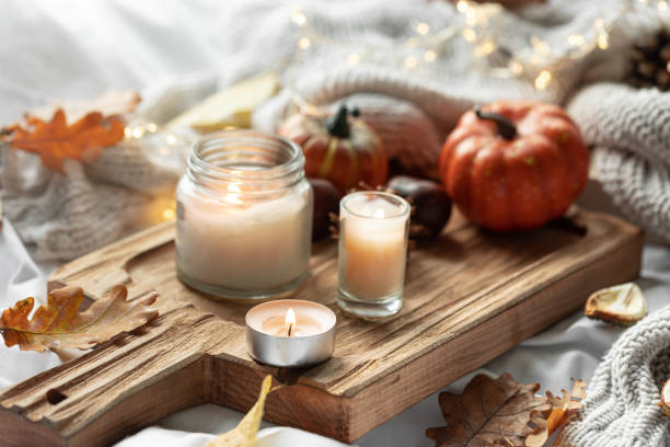 istock Home autumn composition with candles, leaves and knitted element. 1725603958