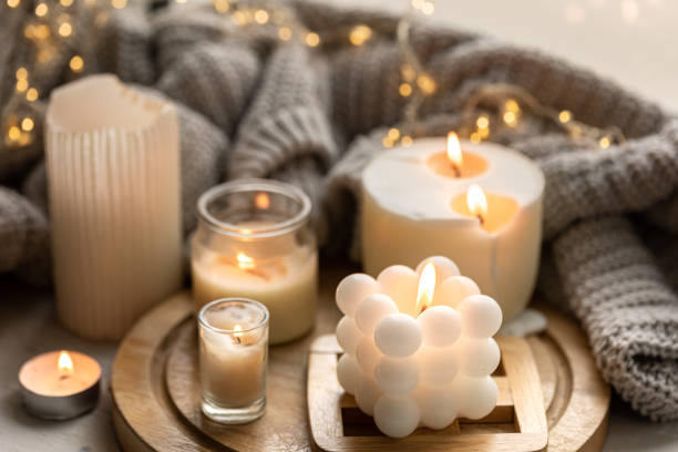 istock A cozy composition with candles, a knitted element and a garland. 1725603963