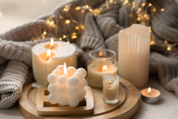 istock A cozy composition with candles, a knitted element and a garland. 1725603969
