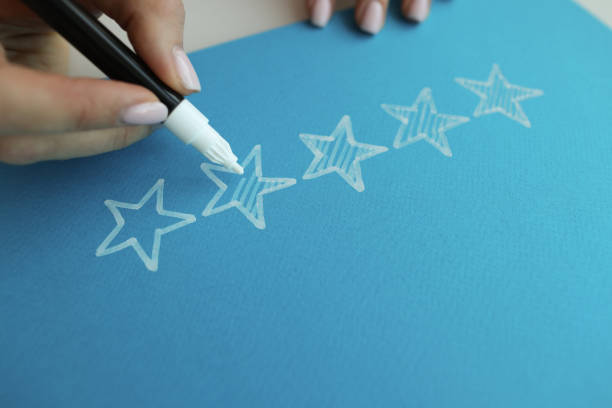 Person draws five stars in recommendations with felt-tip pen Person draws five stars in recommendations with felt-tip pen. Customer feedback concept celebrity endorsements stock pictures, royalty-free photos & images