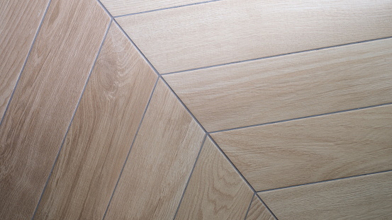 Wooden laminate or parquet in interior. Texture and pattern of natural wood