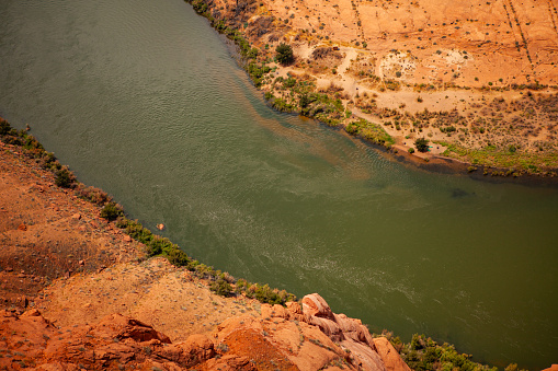 En beautiful view of Horseshoe Bend in Arizona, with the Colorado River. Red rock and green river.
