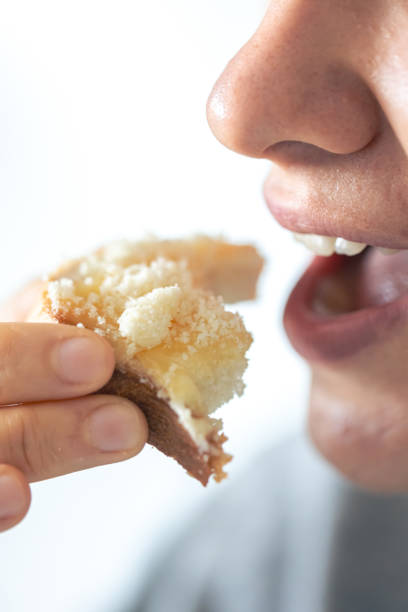 istock A woman eats bread with grated cheese, close-up. 1725638291