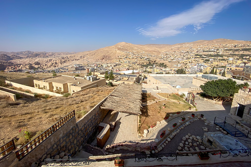 Panoramic view cityscape of Wadi Musa, Jordan against blue sky with clouds