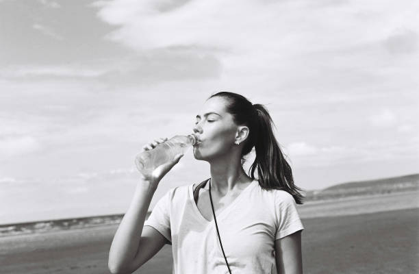 istock Woman drinking bottled water outside 1725660438