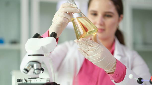 istock Researcher scientist student holding flask with yellow liquid 1725662653