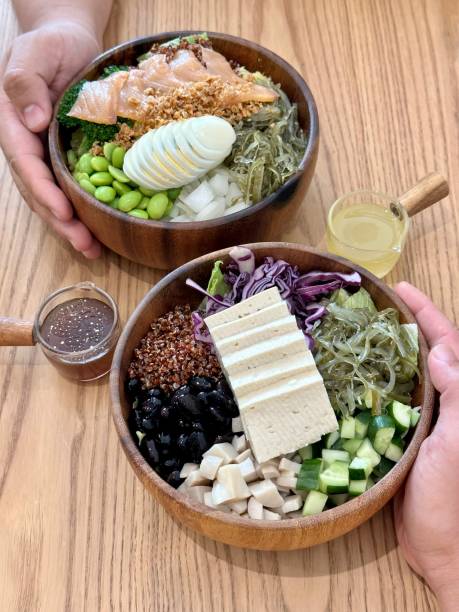 istock Two hands holding two bowl of salad 1725663285