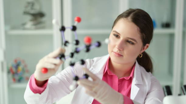 istock Scientist student holding a model of molecule in laboratory 1725668283