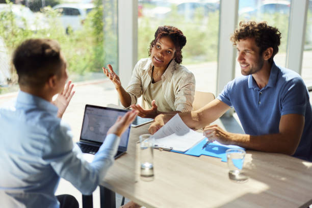istock Diverse couple talking to their agent on a meeting in the office. 1725671021