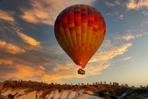 preparing the balloon for flight. filling the ball with gas. bright, colorful hot air balloon on the ground in summer.