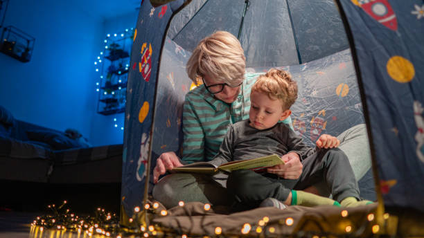istock Happy mother and son playing at home in tent 1725683241