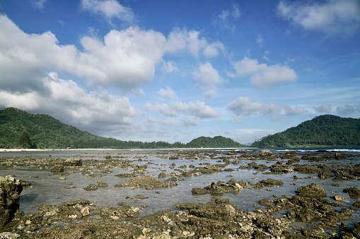 The landscape of the beaches of Bali, Pulo Aceh at low tide near dusk with colored reefs and sunset