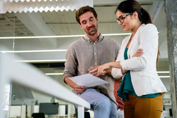 istock Smiling diverse colleagues gather in boardroom brainstorm discuss financial statistics together 1725705346