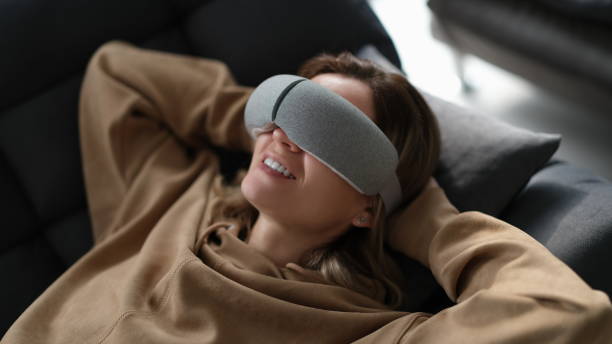 istock Tired woman uses massager while lying on sofa 1725706907