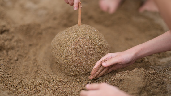 Summer, children hands play and build sand castles on beach. Children vacation vacation at sea