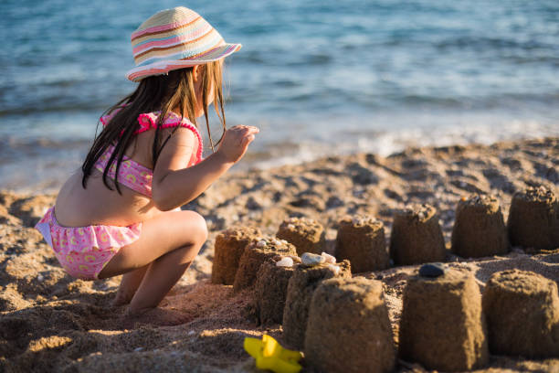 istock The little girl's sandcastle. 1725712695