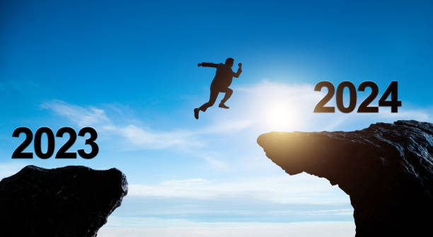 istock Single businessman jumping from 2023 cliff to 2024 1725733332