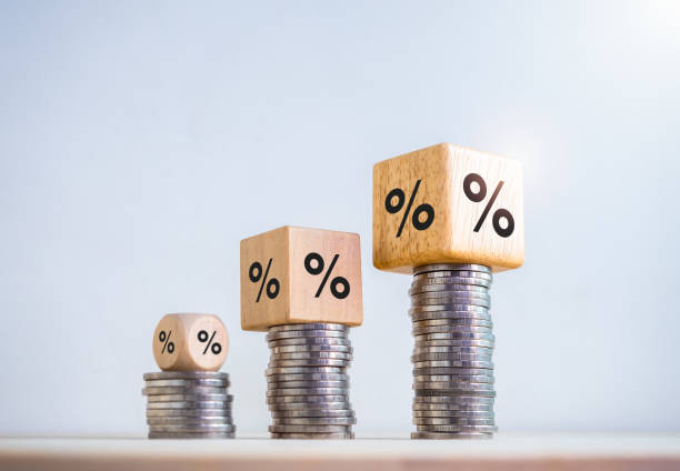 istock Percentage icon on wooden cube blocks expanding on coin stacked bar graph chart steps on white background. Investment, profit, develop income, sales, business growth, economic improvement concepts. 1725734534