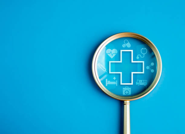 healthcare service, hospital website online search, wellness plan and insurance concept. health, care and medical element icon symbols in magnifying glass lens on blue background with copy space. - physical checkup imagens e fotografias de stock