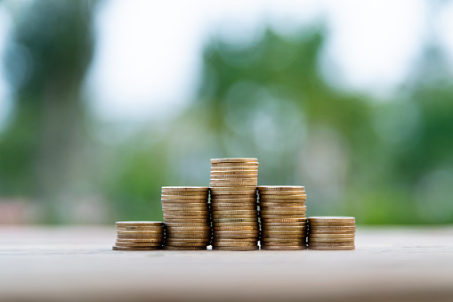 Coin stairs on wooden table.