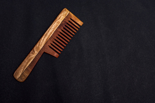 wooden comb on a black background