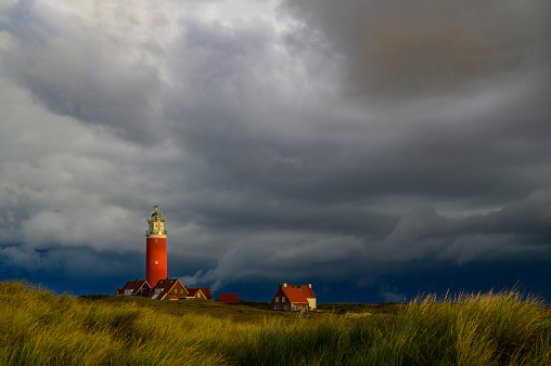 Lighthouse at the Wadden island Texel in the dunes during a stormy autumn morning. The Eierland lighthouse is located at the North point of the island.